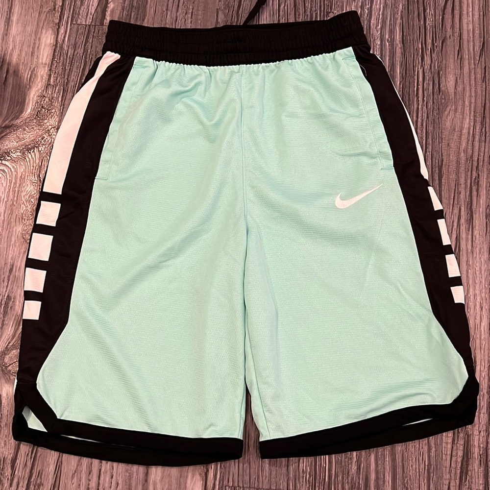 Green back and white Nike basketball shorts.